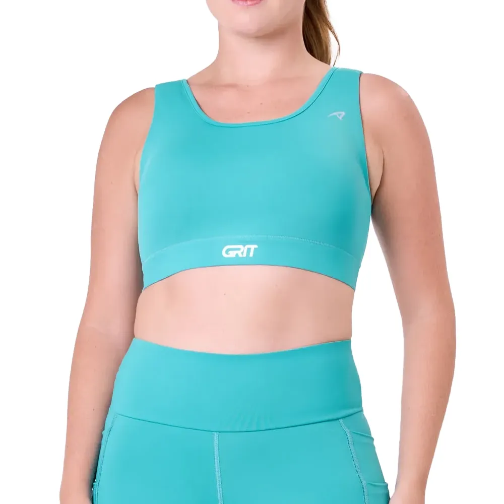 Mulher de costas vestindo top esportivo azul claro Authen com recortes para ventilação e logo GRIT